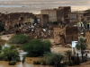 Recent floods in wadi showing destroyed houses